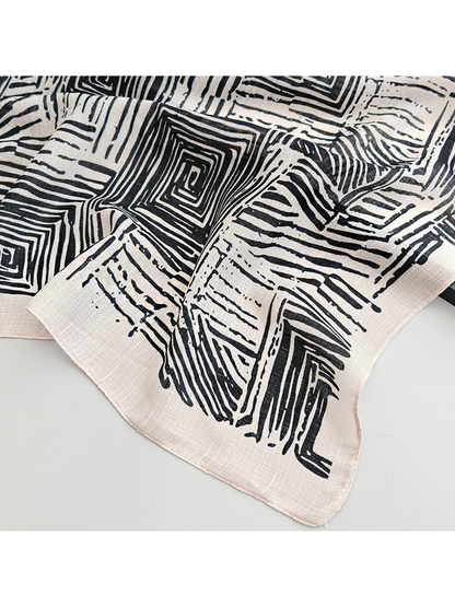 Close-up of the geometric scarf pattern and narrow stitched edge