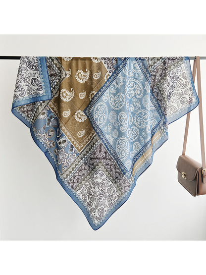 Multicolor square scarf draped to show the patchwork print