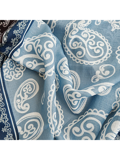 Close-up of the light blue paisley print and fine crosshatch texture