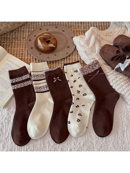 Five brown and ivory crew sock styles arranged together