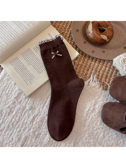 Dark brown crew sock with ribbon rose accent and patterned cuff