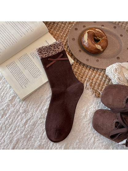 Dark brown crew sock with ribbon bow and leopard-pattern cuff