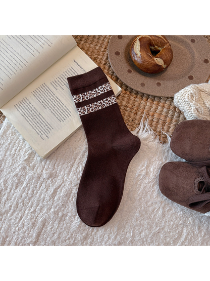 Dark brown crew sock with two ivory leopard-pattern bands