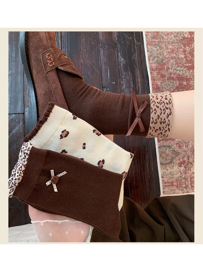 Brown bow-cuff sock worn with a loafer beside two coordinating sock styles