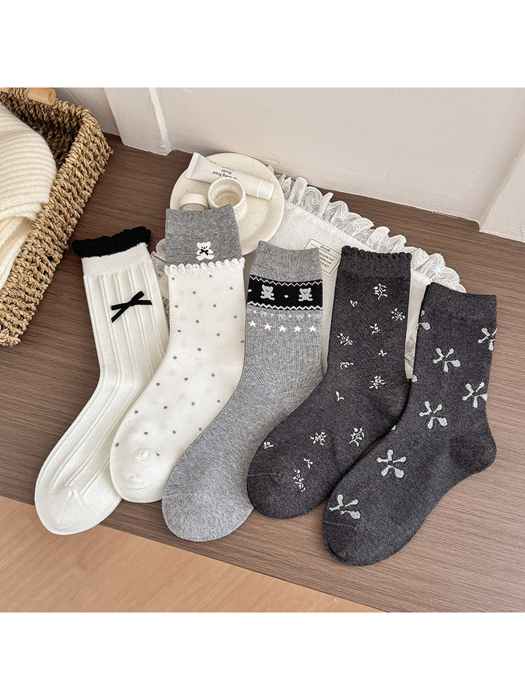 Five crew sock styles displayed together in ivory, gray and dark gray