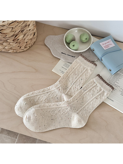 Ivory flecked crew socks with raised cable pattern and brown scalloped cuffs