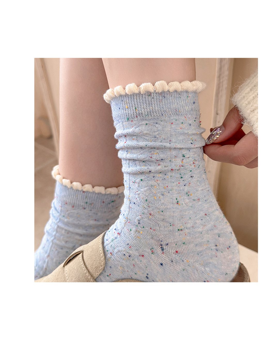 Close-up of Light Blue flecked socks with ivory scalloped cuffs