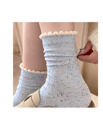 Close-up of Light Blue flecked socks with ivory scalloped cuffs