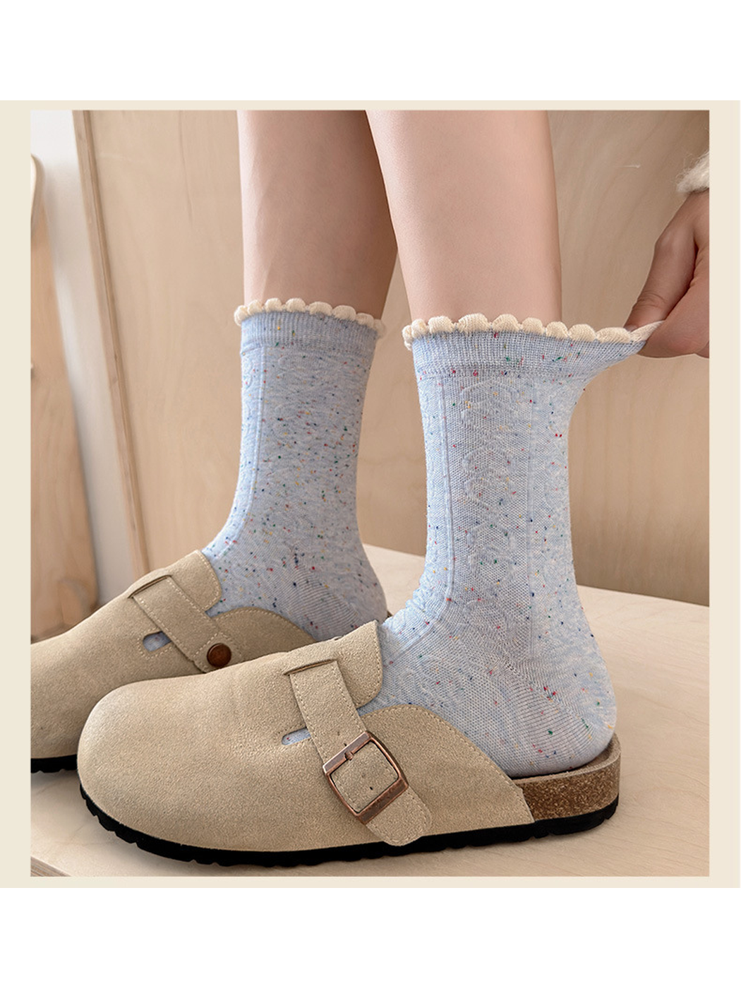 Close-up of a Light Blue flecked sock cuff pulled outward to show its edge construction