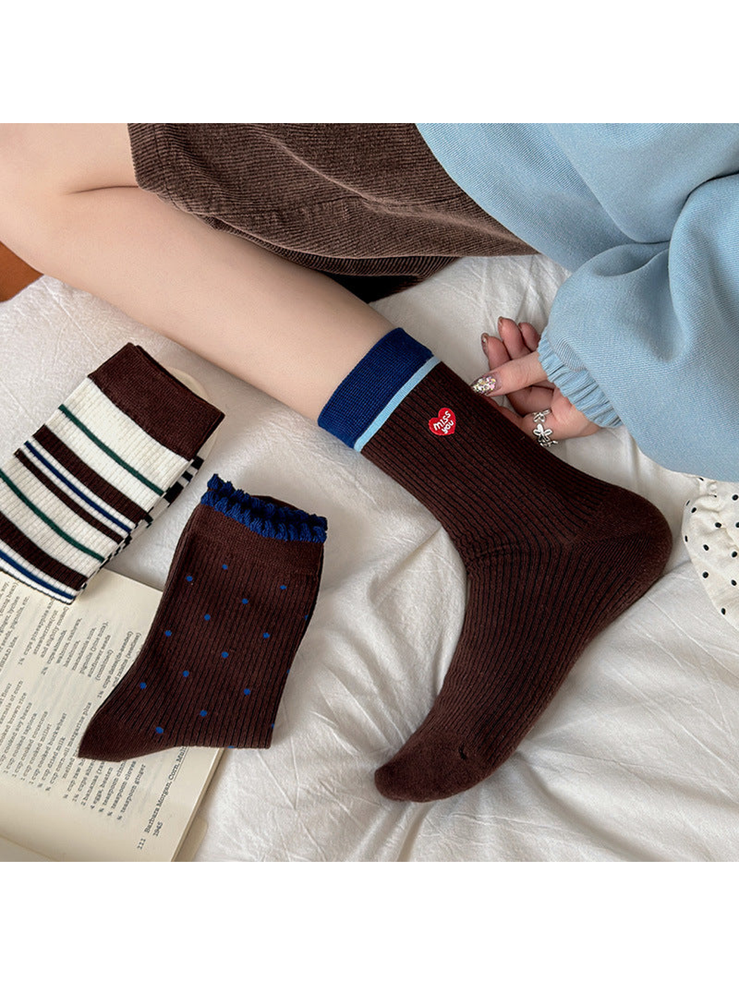 Brown Heart crew socks worn with coordinating striped and dotted styles nearby