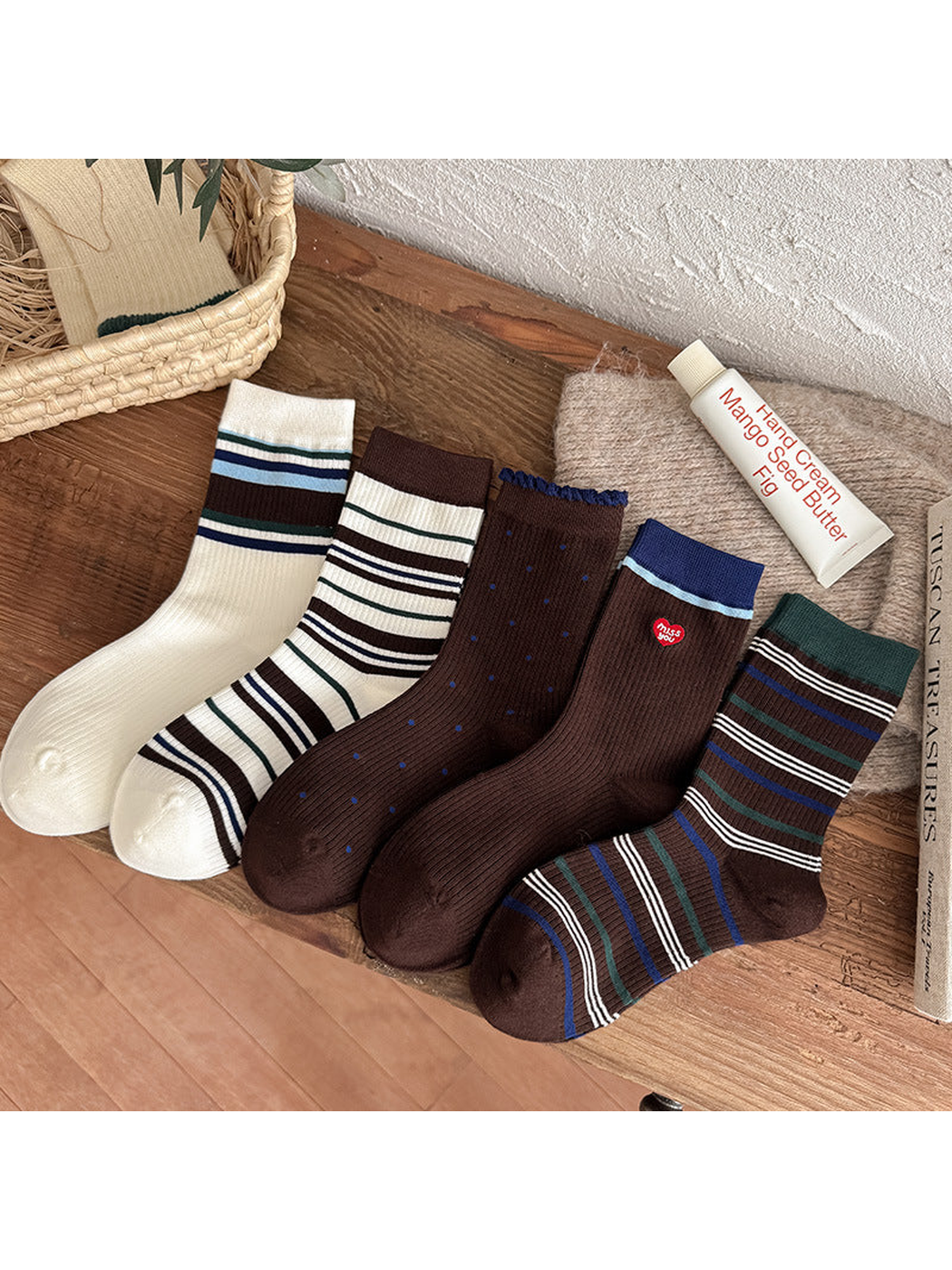 Five crew sock styles arranged together on a wooden surface
