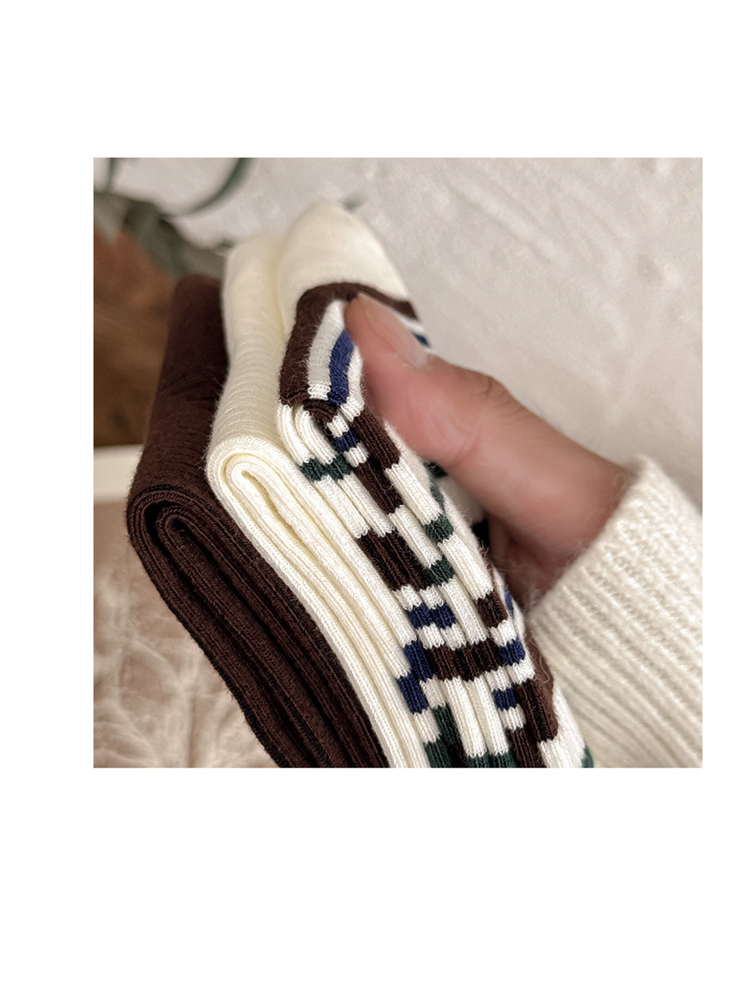 Close-up of fine vertical ribbing on the brown and ivory sock styles