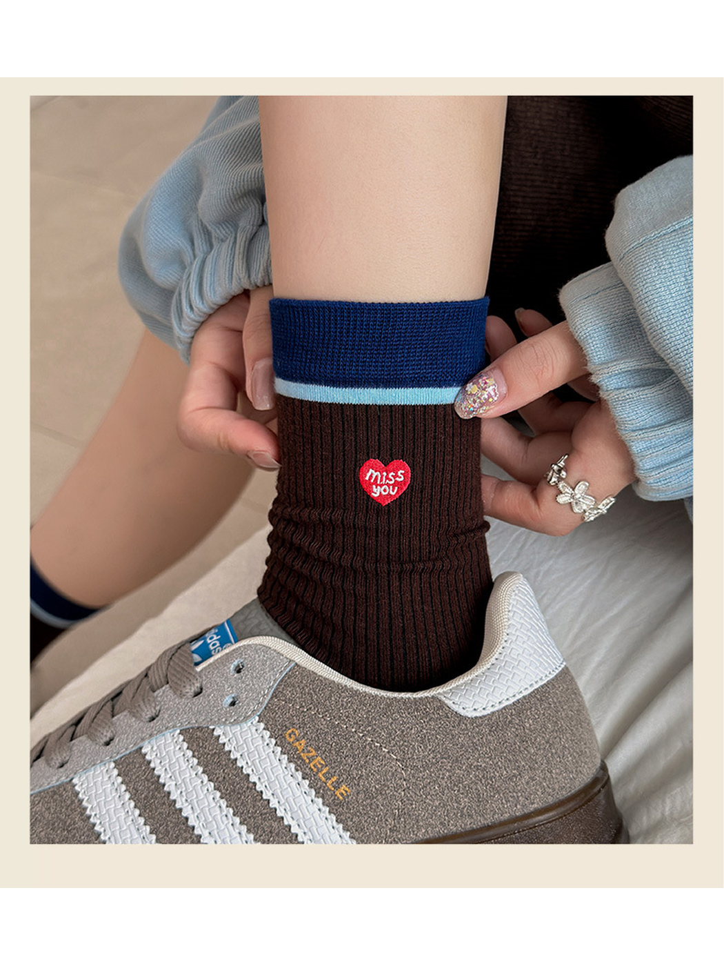 Close-up of the Brown Heart sock cuff and heart patch above a sneaker