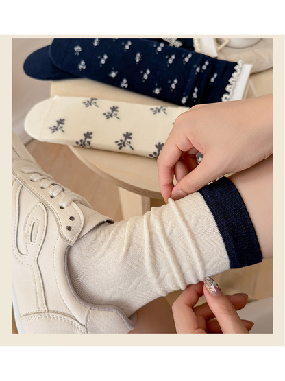 Close-up of the Contrast Cuff sock's navy ribbed cuff and cable texture