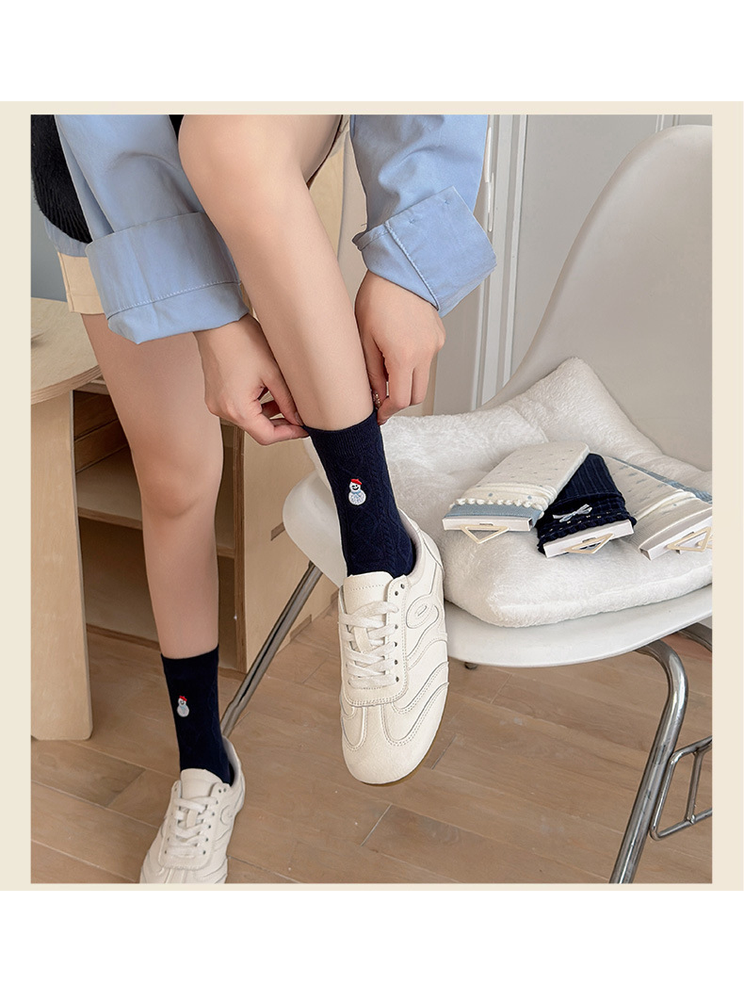 Navy Snowman crew socks worn with cream sneakers