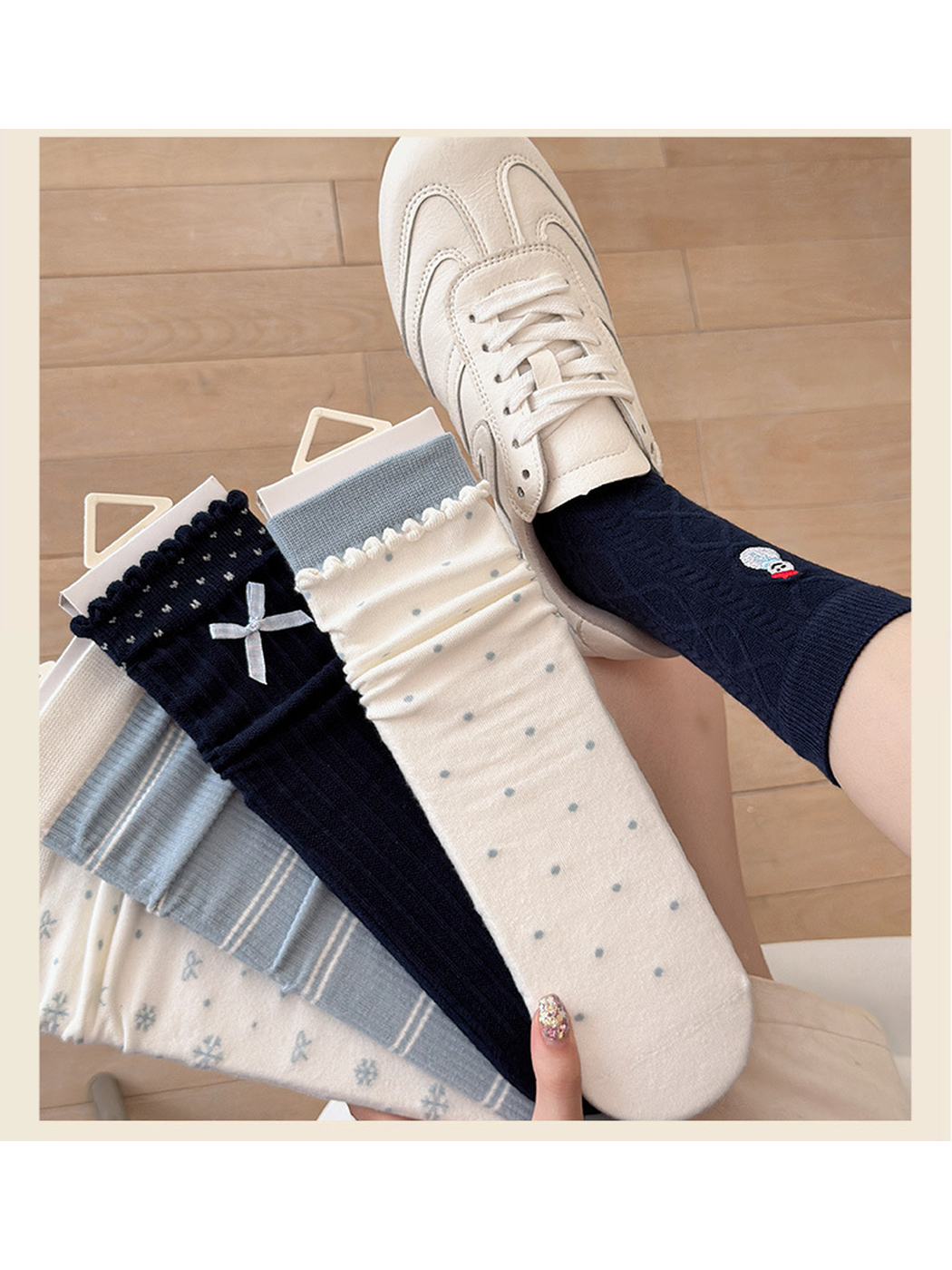 Navy Snowman crew sock worn with a cream sneaker beside the five sock styles