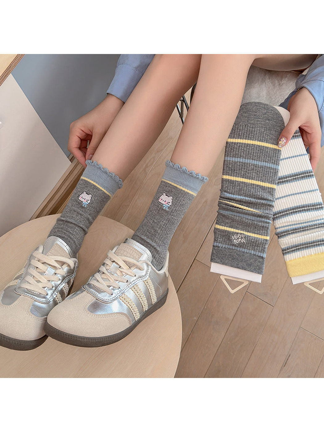 Gray Cat crew socks worn with silver-tone sneakers beside two striped styles
