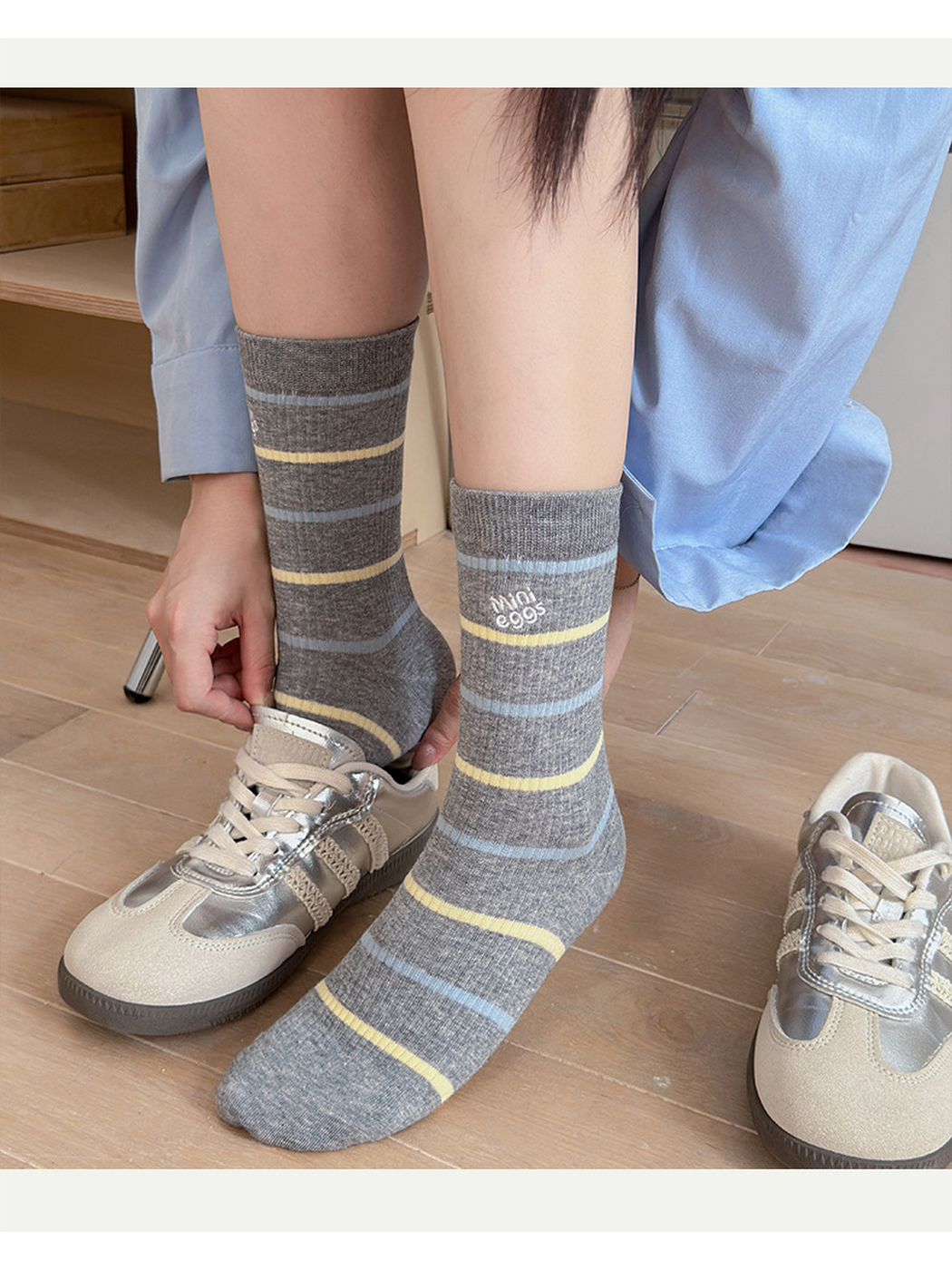 Gray Lettering crew socks with pale blue and yellow stripes worn with sneakers