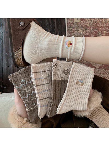 Neutral crew socks in five styles displayed in a cozy setting