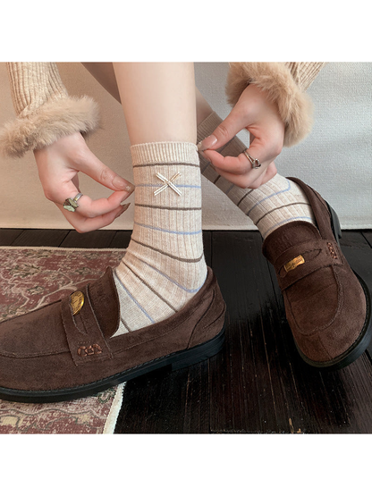 Striped Bow crew socks styled with brown loafers