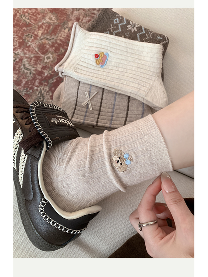 Dog crew sock styled with a brown sneaker and coordinating socks