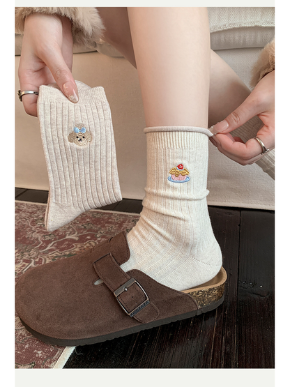 Cake crew sock styled with a brown clog beside the Dog style