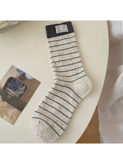 Stripes ivory crew sock with dark horizontal stripes and cuff patch