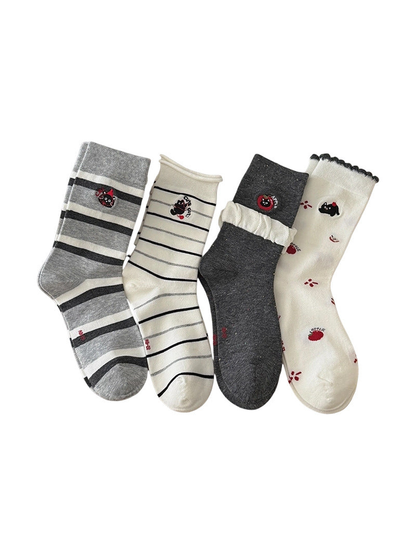 Four crew sock styles in ivory and gray displayed on a white background