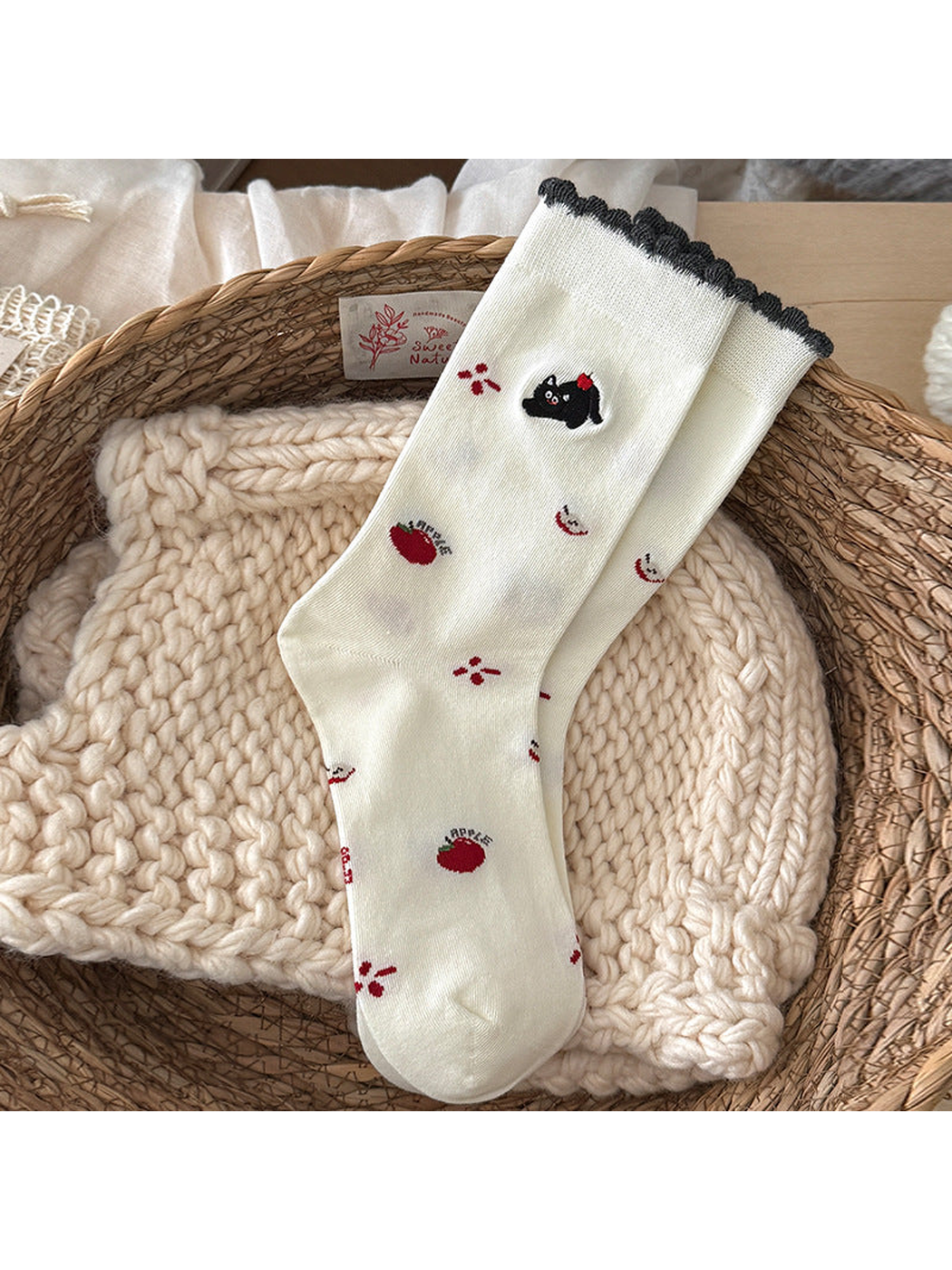 Apple Cat ivory crew socks with a dark scalloped cuff