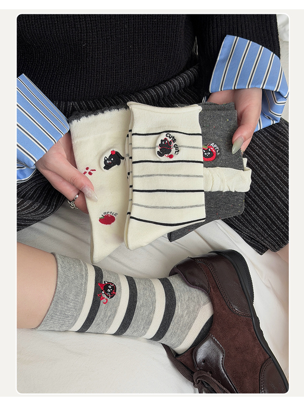 Wide Stripe gray crew socks worn with brown sneakers while three other styles are held