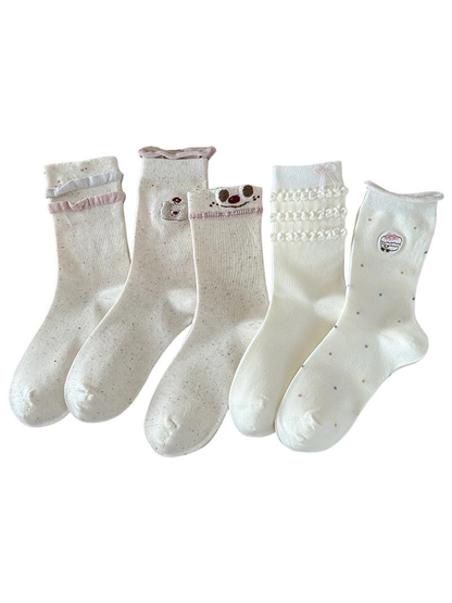 Bow, Cupcake, Bear, Smiley and Ruffle crew sock styles on a white background