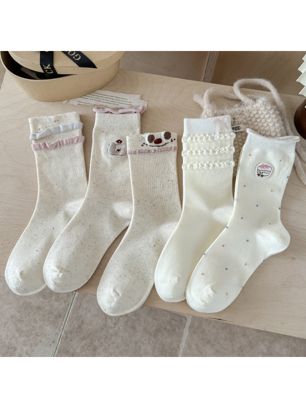 Bow, Cupcake, Bear, Smiley and Ruffle crew sock styles displayed together