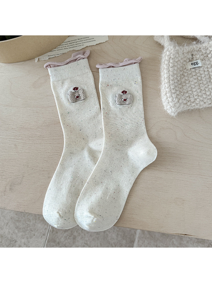 Bear beige crew socks with pink rolled cuffs and embroidered bear motifs