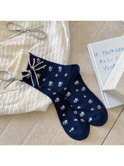 Floral navy crew socks with ivory cuffs and bow accents