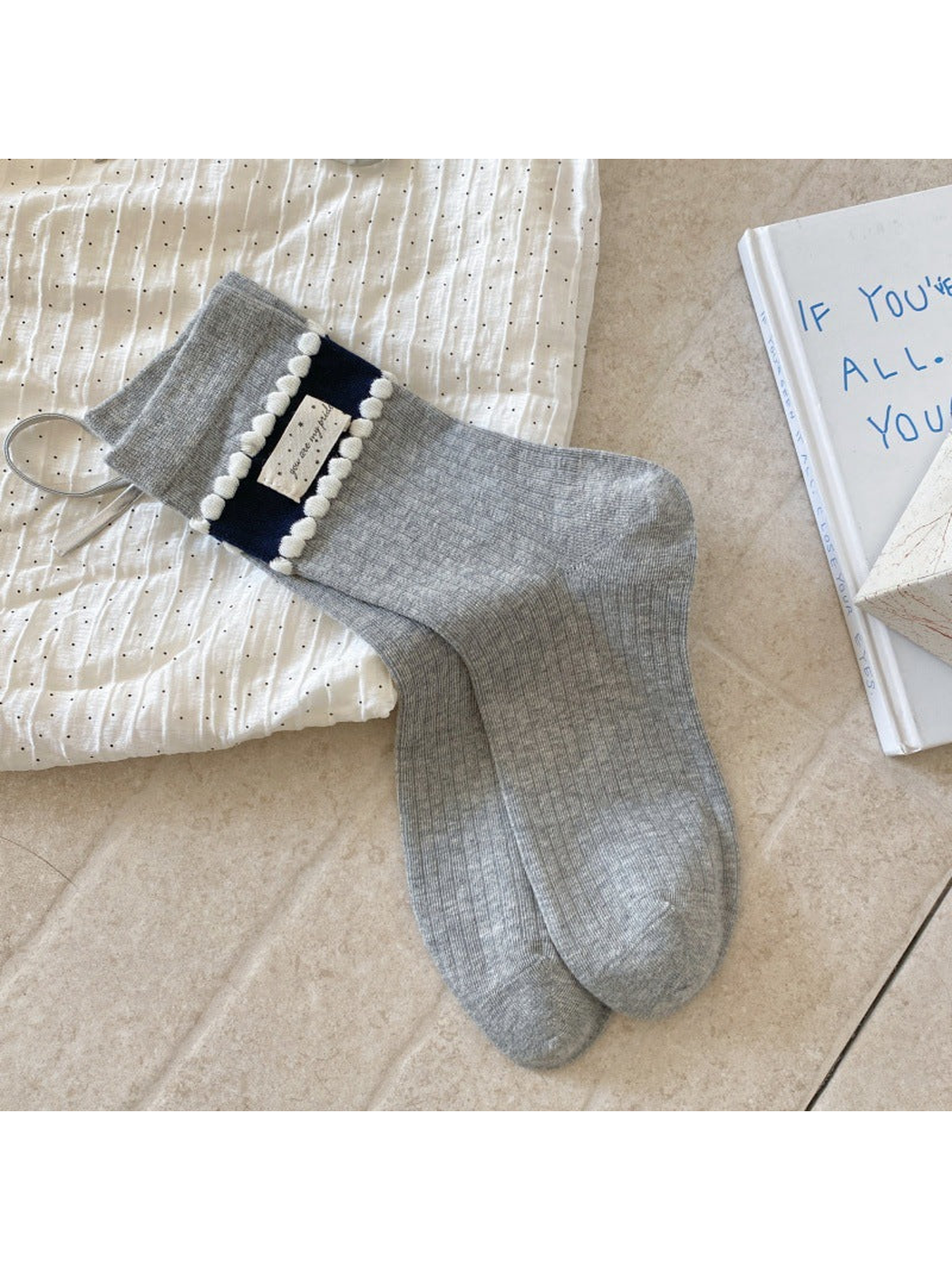 Pom-Pom gray crew socks with navy cuff bands and ivory trim