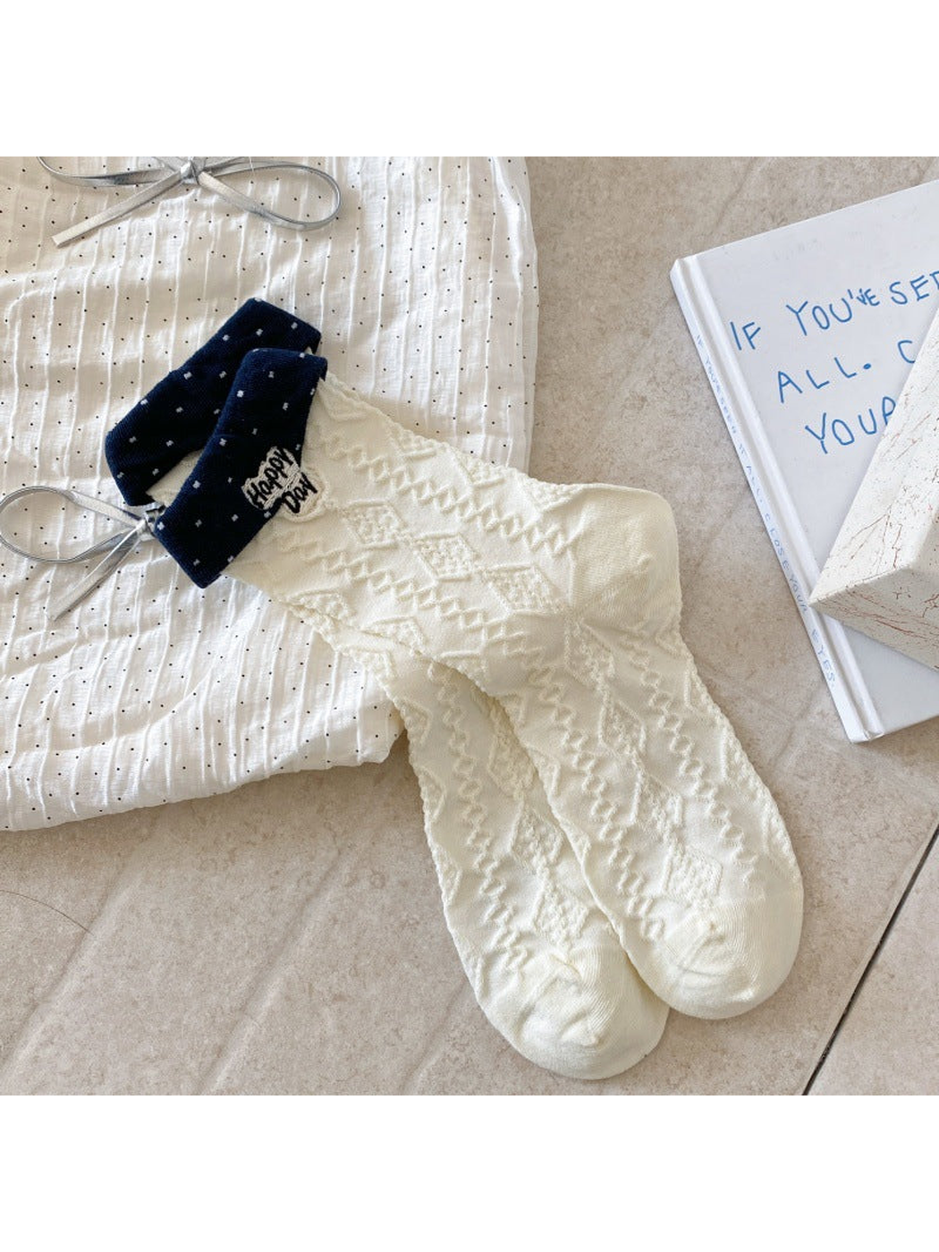 Geometric ivory crew socks with textured pattern and navy cuffs
