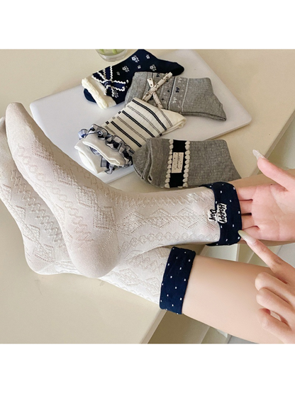 Geometric ivory socks worn with navy fold-over cuffs