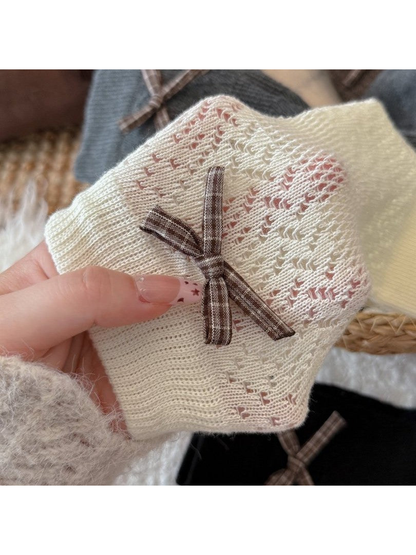Close-up of the plaid bow and pointelle pattern