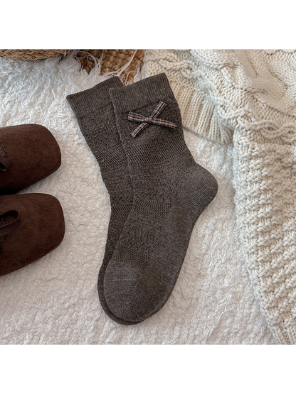 Brown crew socks with a plaid bow