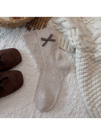 Beige pointelle crew socks with a plaid bow