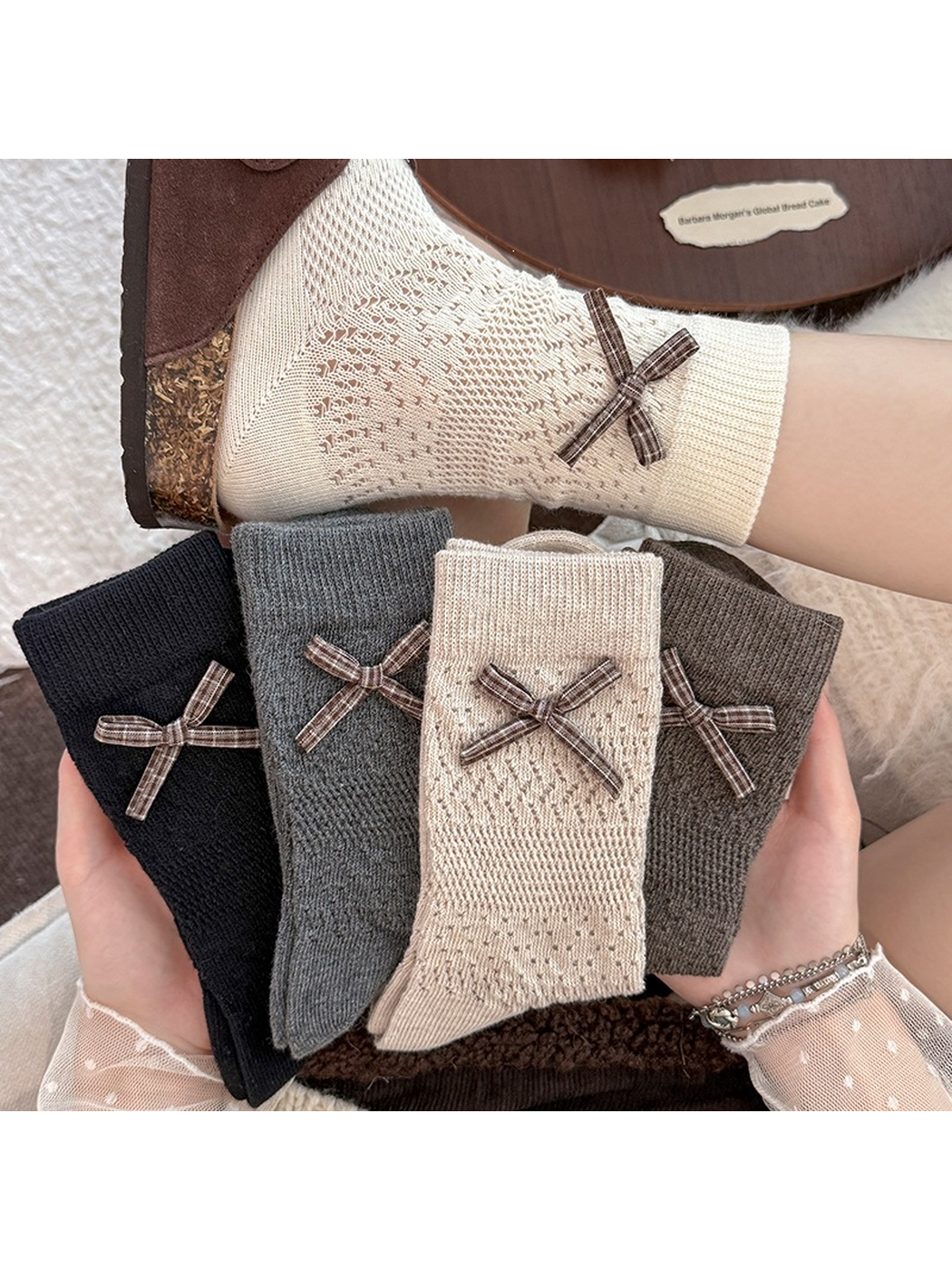 Five bow crew sock colors displayed with a beige pair worn