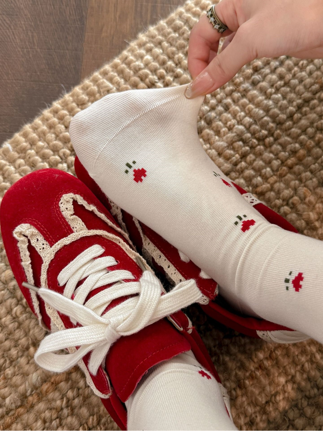 Floral crew socks styled with red lace-trim sneakers