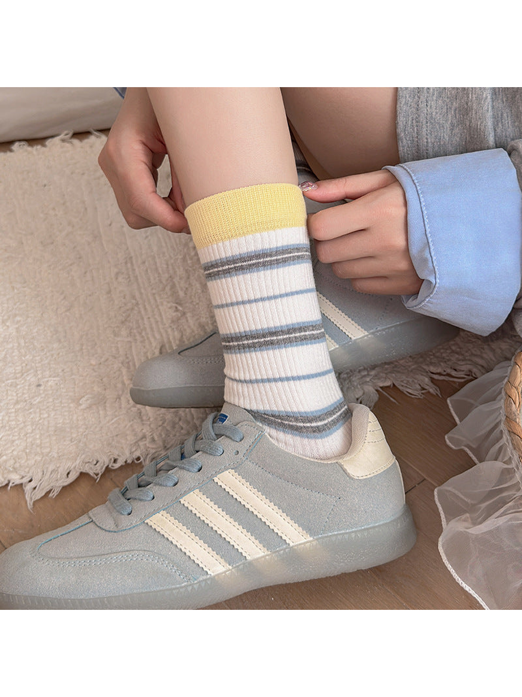 Yellow Cuff striped socks worn with blue sneakers
