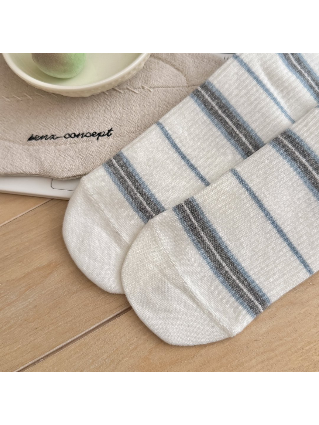 Close-up of rounded toes on white striped socks