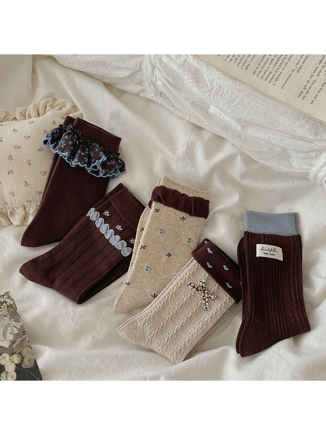 Five crew sock styles arranged together on neutral bedding