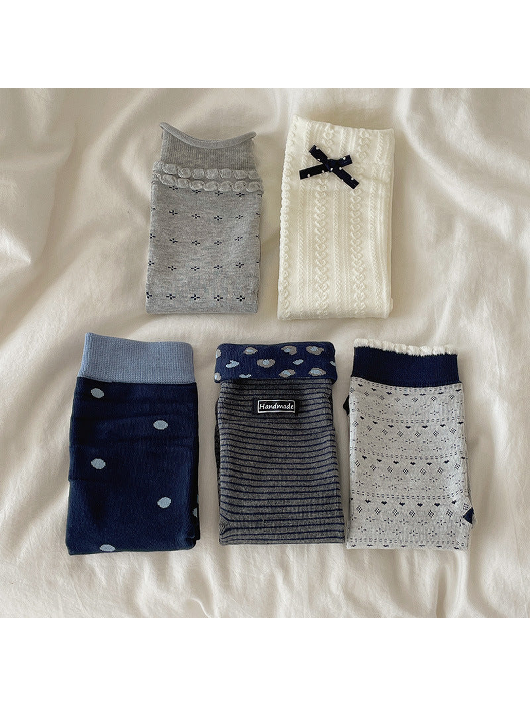 Five crew sock colors and patterns arranged in a folded display