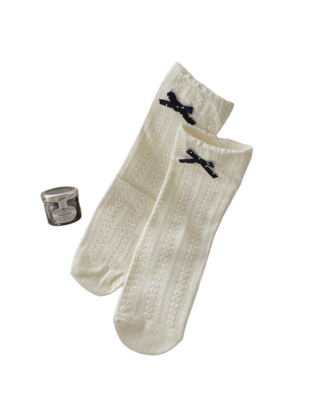Ivory crew socks with bow accents and a textured vertical pattern