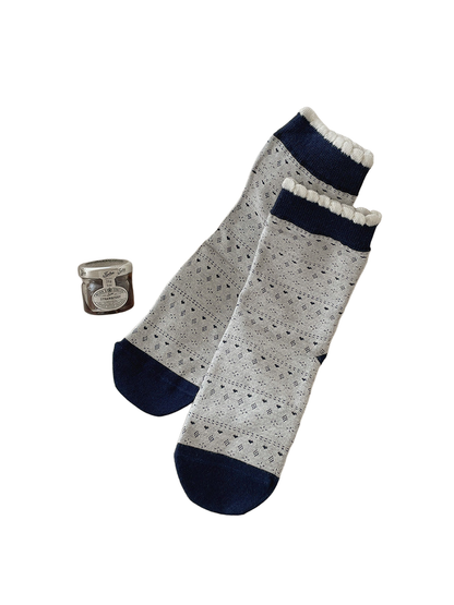 Light Gray crew socks with geometric bands and navy cuffs and toes