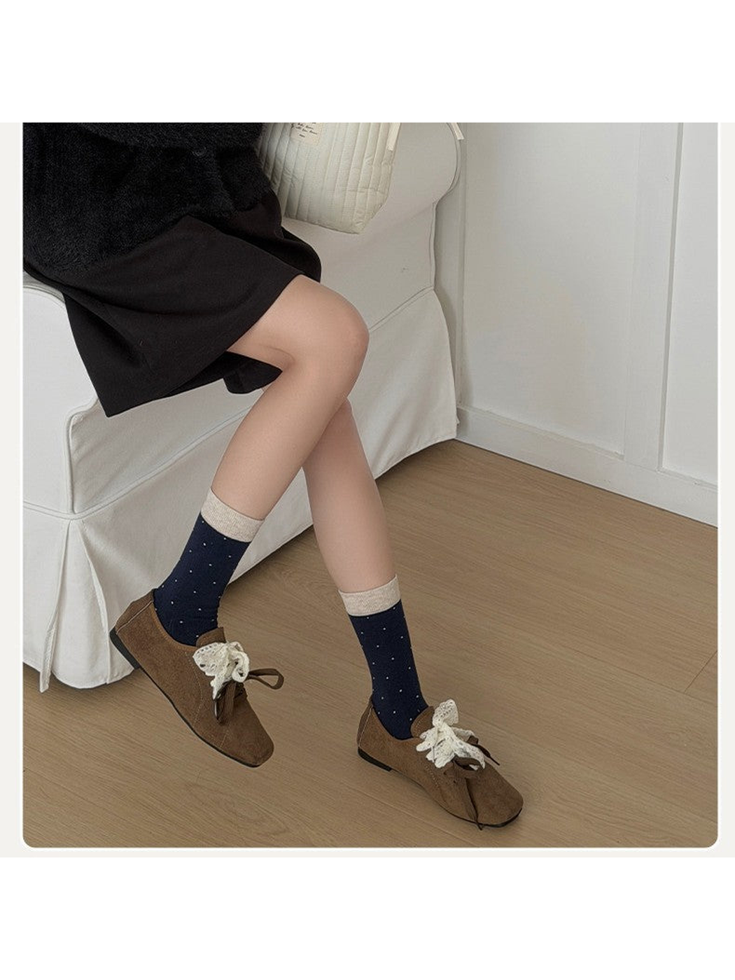 Navy polka-dot crew socks styled with brown shoes