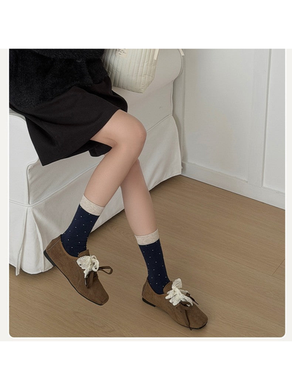 Navy polka-dot crew socks styled with brown shoes
